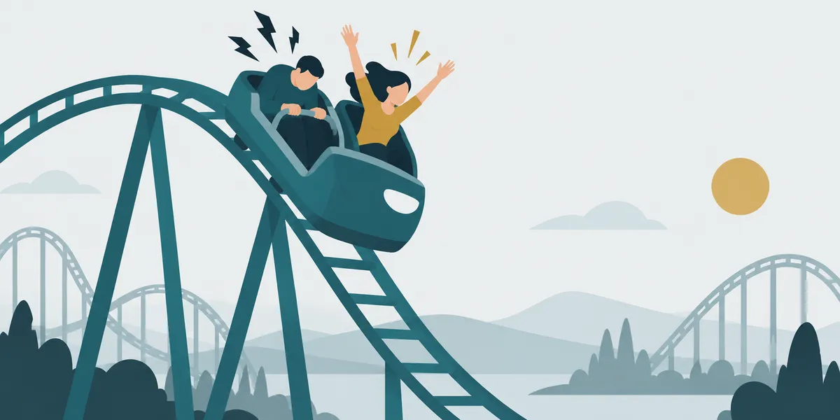 A roller coaster track at its drop; in the car, one rider hunched and holding on with jagged lines, the other open with arms up and gold, on the same track